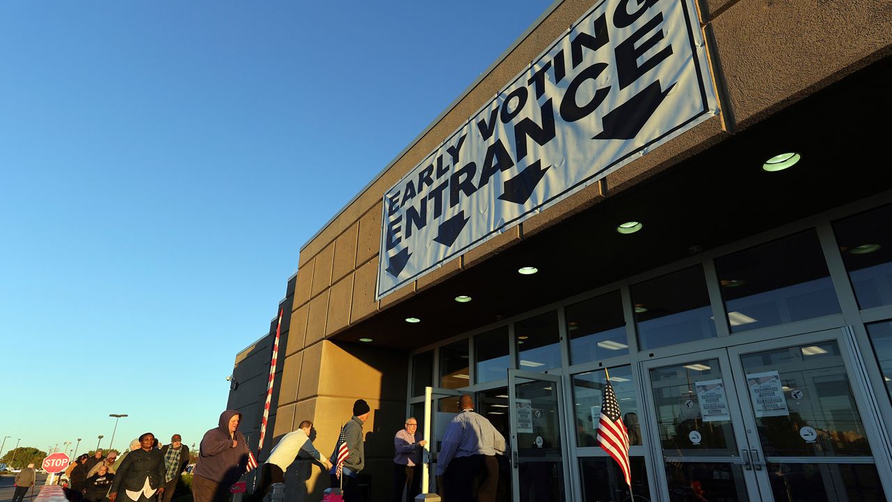 Voters enter the early voting center for the first day of in person early voting at the Franklin County Board of Elections in Columbus, Ohio, Tuesday, Oct. 8, 2024. (AP Photo/Paul Vernon)