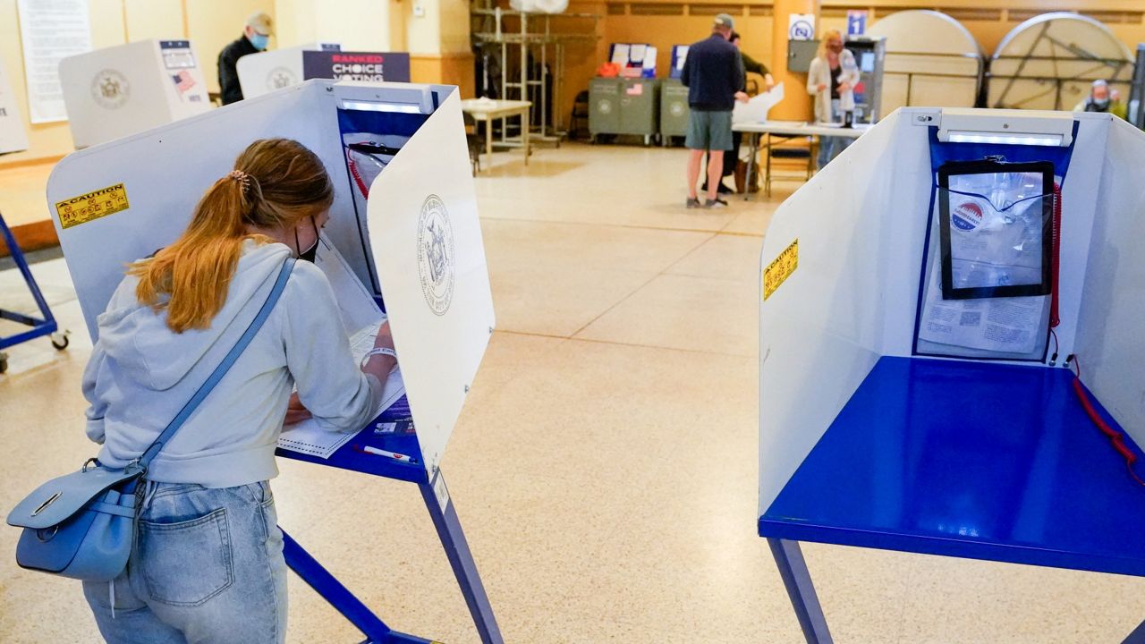 A person wears a vote while voting (Provided: Associated Press)
