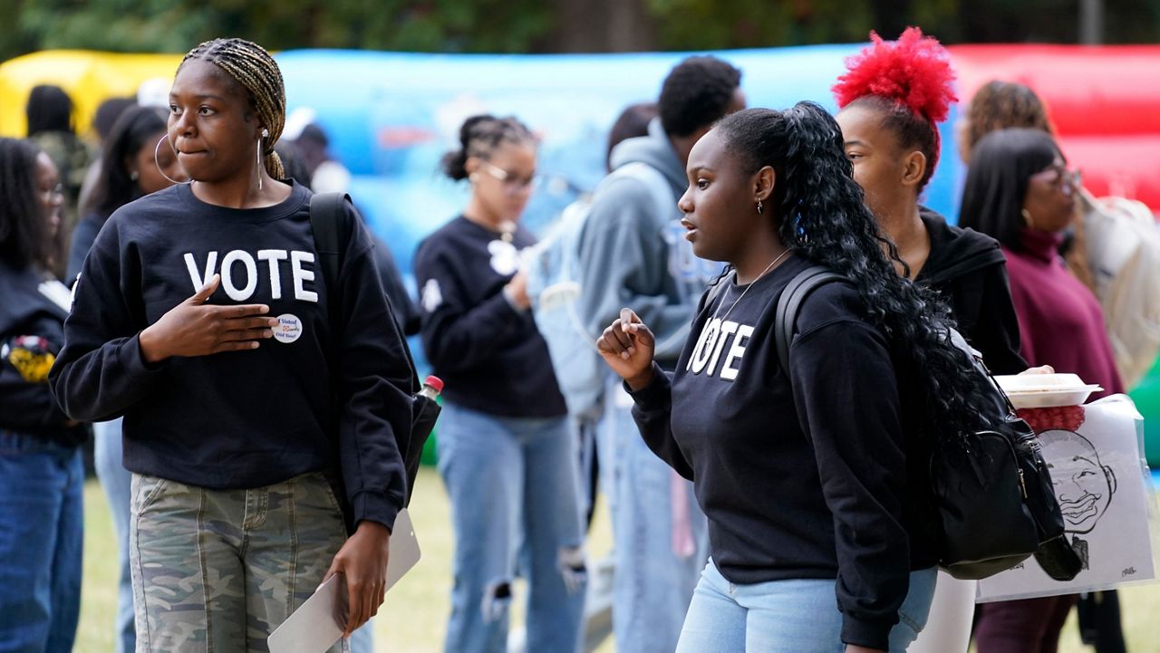 Tamera Drain, left, and Lauren Miller chat during a get-out-the-vote rally at North Carolina A&T in Greensboro, N.C., Monday, Oct. 28, 2024. (AP Photo/Chuck Burton)