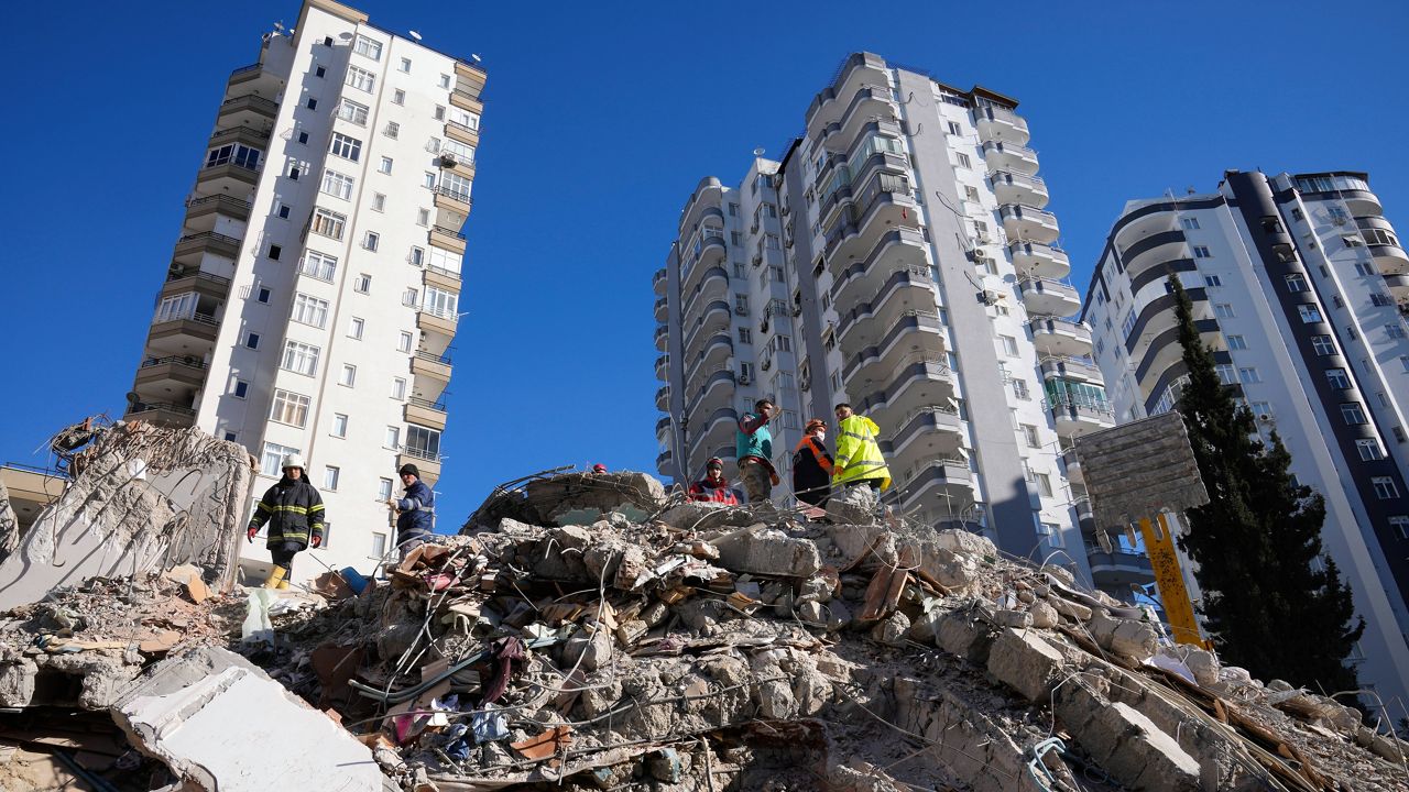 Emergency teams search for people Tuesday in the rubble of a destroyed building in Adana, southern Turkey. (AP Photo/Hussein Malla) 