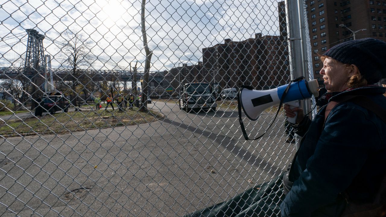 Activists blocked the entrance to East River Park Tuesday, Dec. 7, 2021, in an effort to stop construction crews from removing the park's trees. (AP Photo/Mary Altaffer)