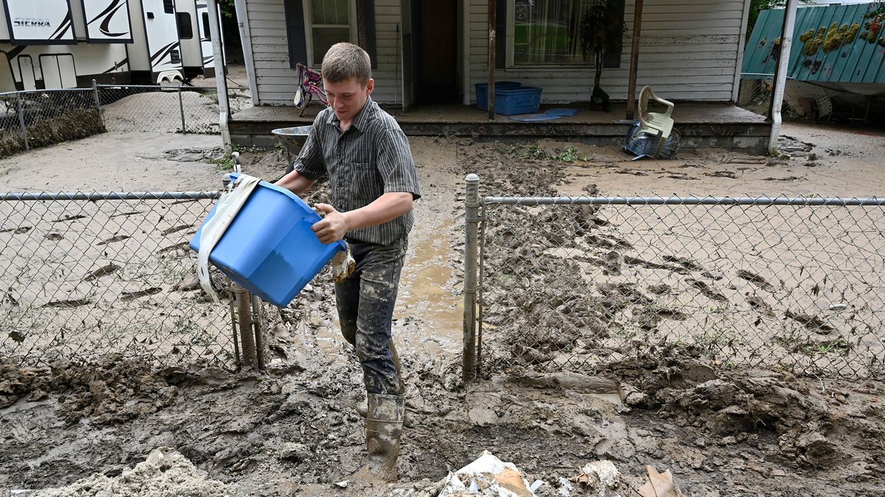 Members of the local Mennonite community remove mud filled debris from homes following flooding at Ogden Hollar in Hindman, Ky., Saturday, July 30, 2022. (AP Photo/Timothy D. Easley)