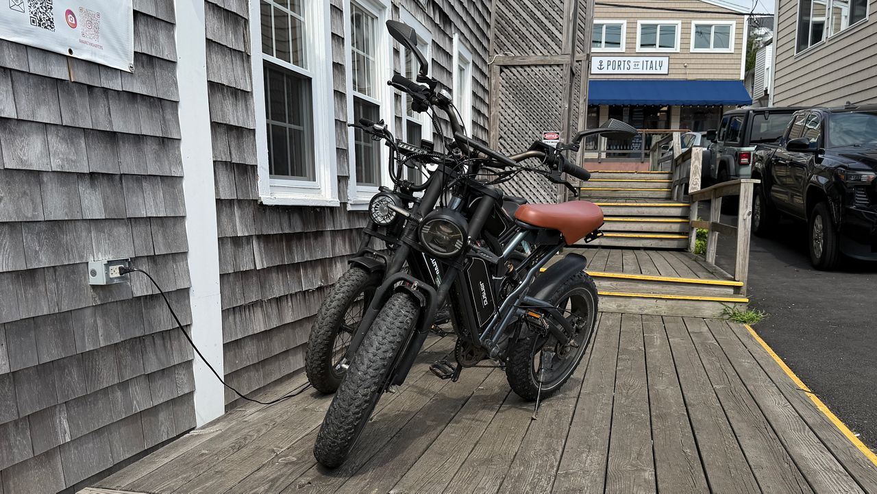 E-bikes are a popular way to get around Boothbay Harbor, but they are not allowed on the footbridge. (Spectrum News/Susan Cover)