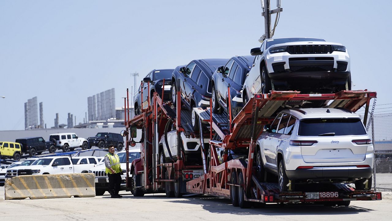 A transport carrying new cars arrives at a Stellantis facility in Belvidere. Ill., on July 10. (AP Photo/Charles Rex Arbogast)