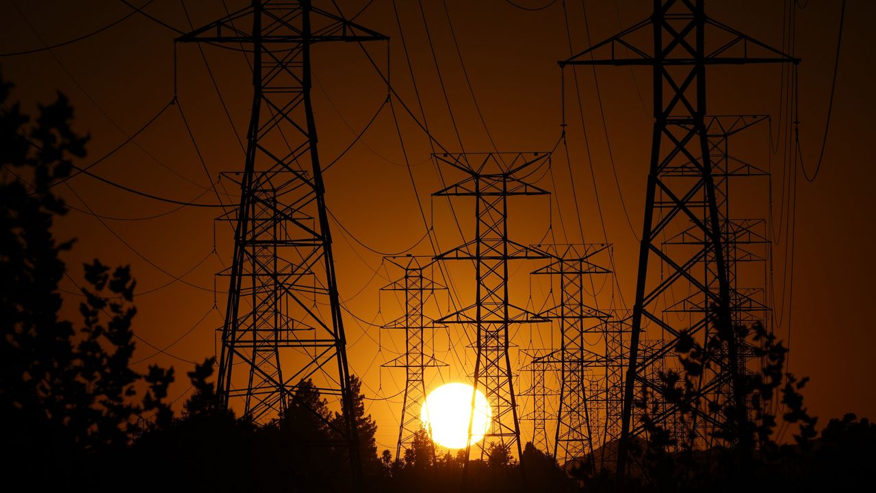 The sun sets behind high tension power lines on Sept. 23, 2024, in the Porter Ranch section of Los Angeles. (AP Photo/Mark J. Terrill, File)