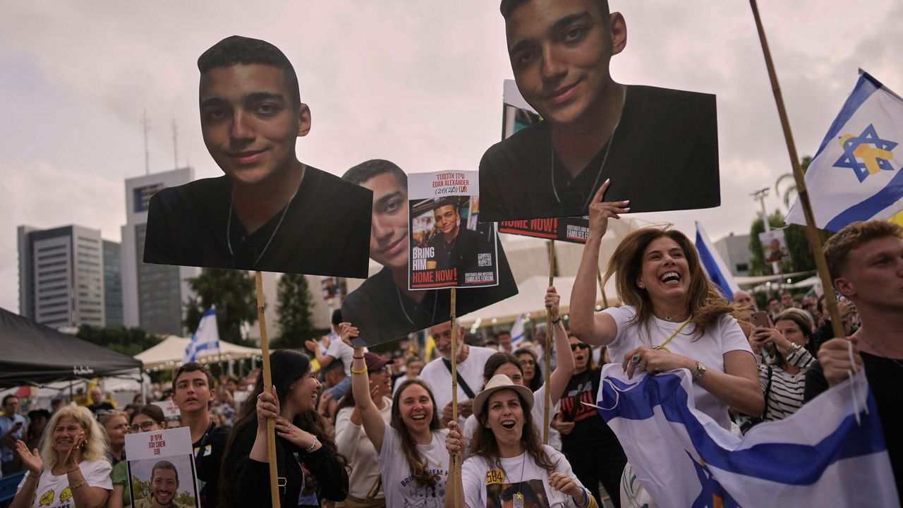 People react as they gather to watch a live broadcast of Israeli-American soldier Edan Alexander to be released from Hamas captivity in Gaza, at a plaza known as the hostages square in Tel Aviv, Monday, May 12, 2025. Alexander was abducted during the Hamas-led attack on his base on October 7, 2023. (AP Photo/Oded Balilty)
