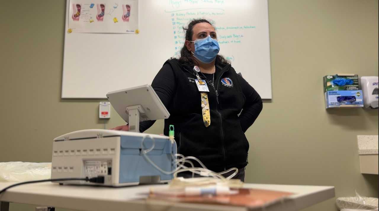Bridget Guerndt sets up an at-home dialysis machine