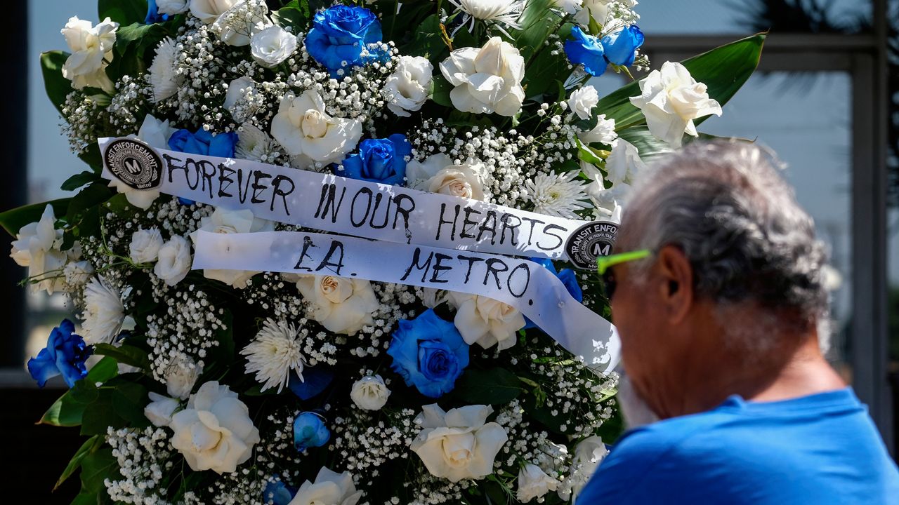 A wreath is displayed at a memorial outside El Monte City Hall Wednesday after two police officers were shot and killed Tuesday at a motel in El Monte, Calif. (AP Photo/Ringo H.W. Chiu)
