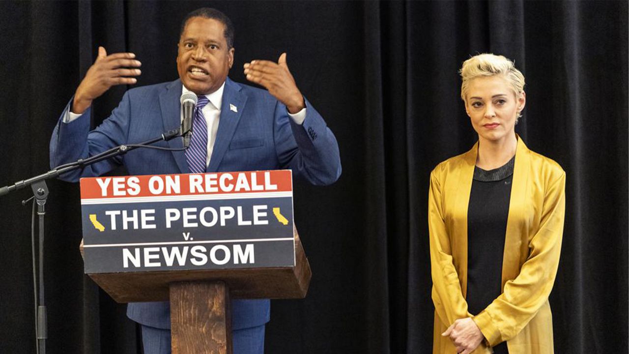 Republican conservative radio talk show host Larry Elder with former actress and activist Rose McGowan hold a news conference at the Luxe Hotel Sunset Boulevard in Los Angeles Sunday, Sept. 12, 2021. (AP Photo/Damian Dovarganes)