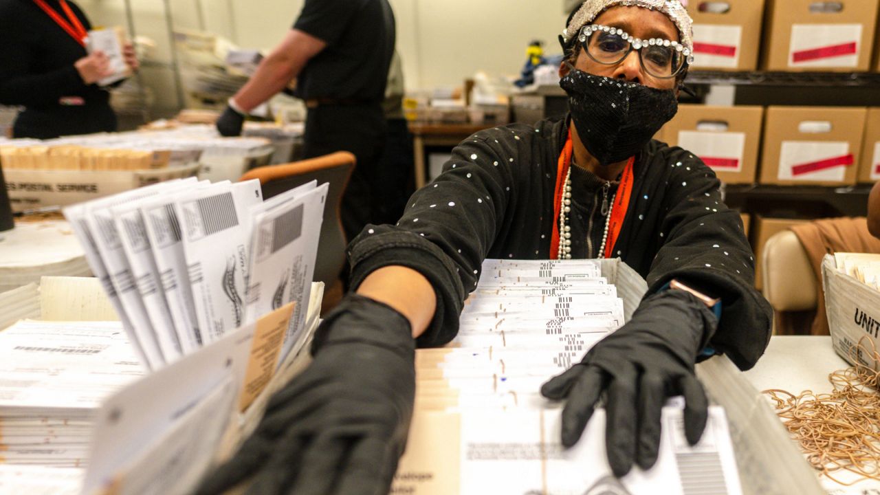 Election worker processing mail-in ballots (Watchara Phomicinda/The Orange County Register via AP)