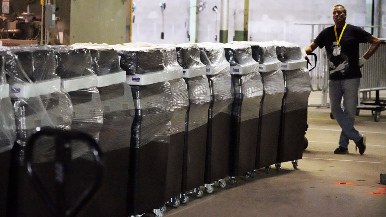 Voting equipment at the Allegheny County Election Division Elections warehouse in Pittsburgh is prepared to be moved to polling sites throughout Allegheny County, Thursday, Nov. 3, 2022. (AP Photo/Gene J. Puskar, File)