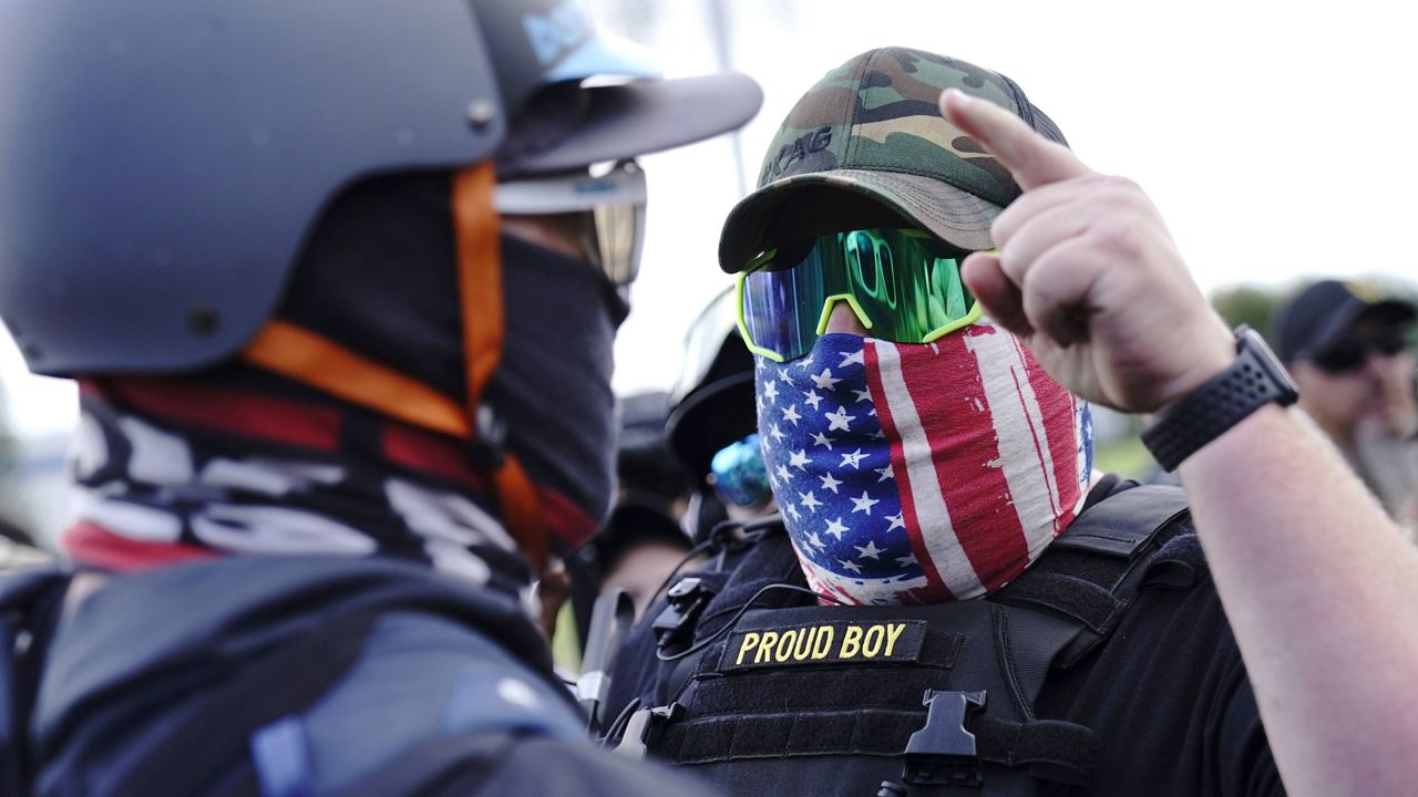 A member of the Proud Boys gestures toward a counter protester at a rally in Portland, Ore., on Sept. 26. (AP Photo/John Locher, File) 