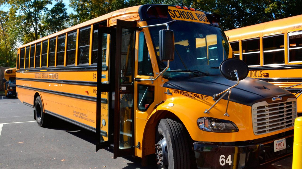 An electric school bus sits in a bus yard in Beverly, Mass. (AP Photo/Michael Casey)