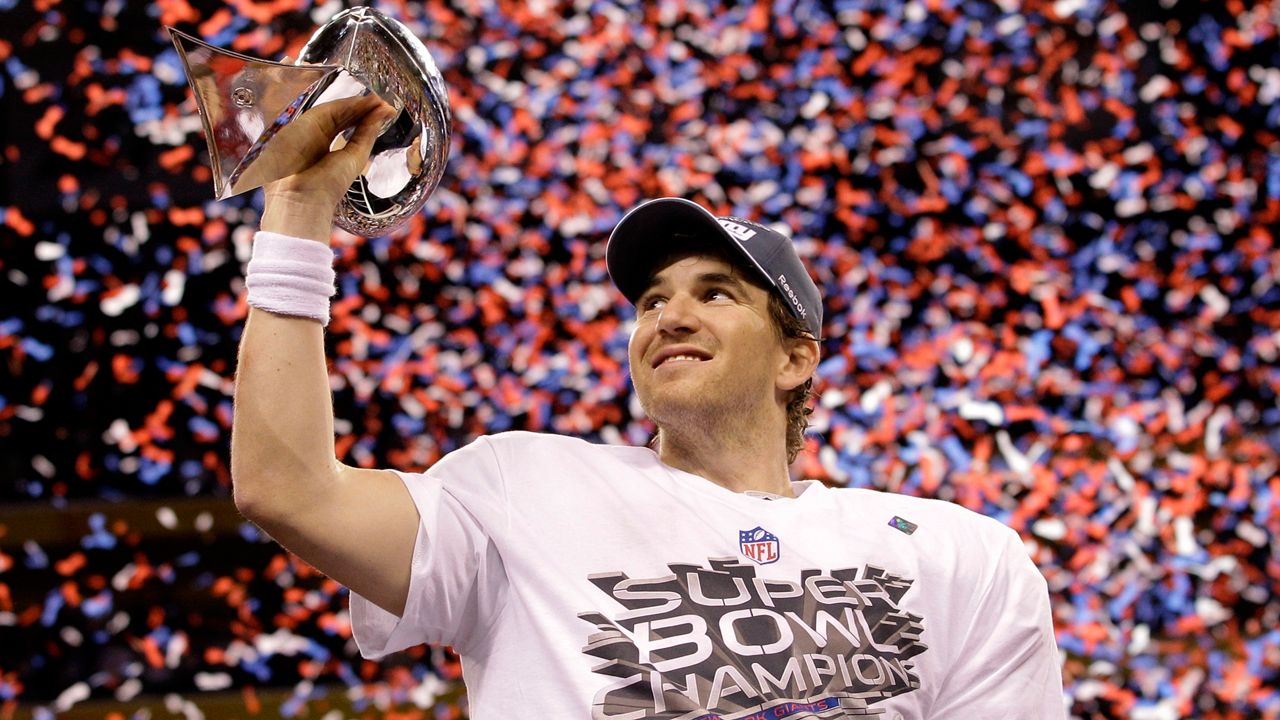 New York Giants quarterback Eli Manning holds up the Vince Lombardi Trophy while celebrating his team's 21-17 win over the New England Patriots in the NFL Super Bowl XLVI football game, Feb. 5, 2012, in Indianapolis. (AP Photo/David J. Phillip, File)