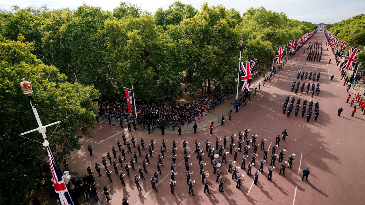 The State Gun Carriage carries the coffin of Queen Elizabeth II in the ceremonial procession following her state funeral at Westminster Abbey. (Zac Goodwin/Pool Photo via AP)