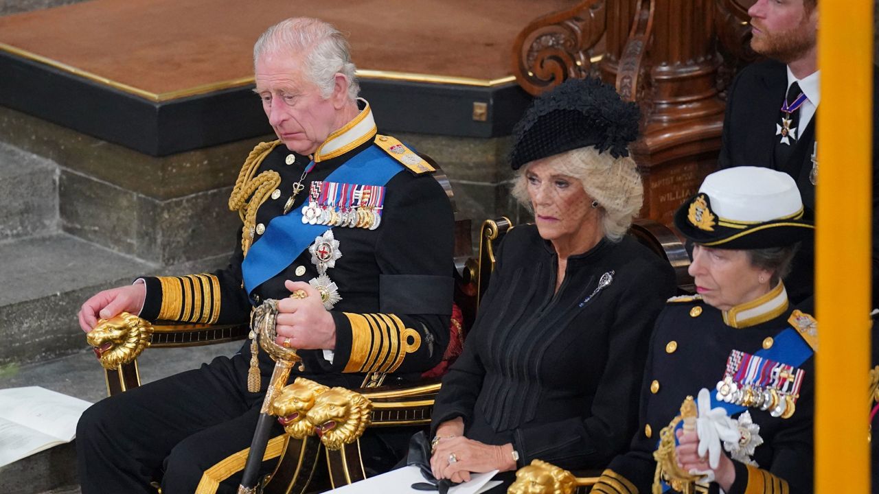 King Charles III; Camilla, the queen consort; and Princess Anne sit in front of the coffin of Queen Elizabeth II.(Ben Stansall/Pool via AP)