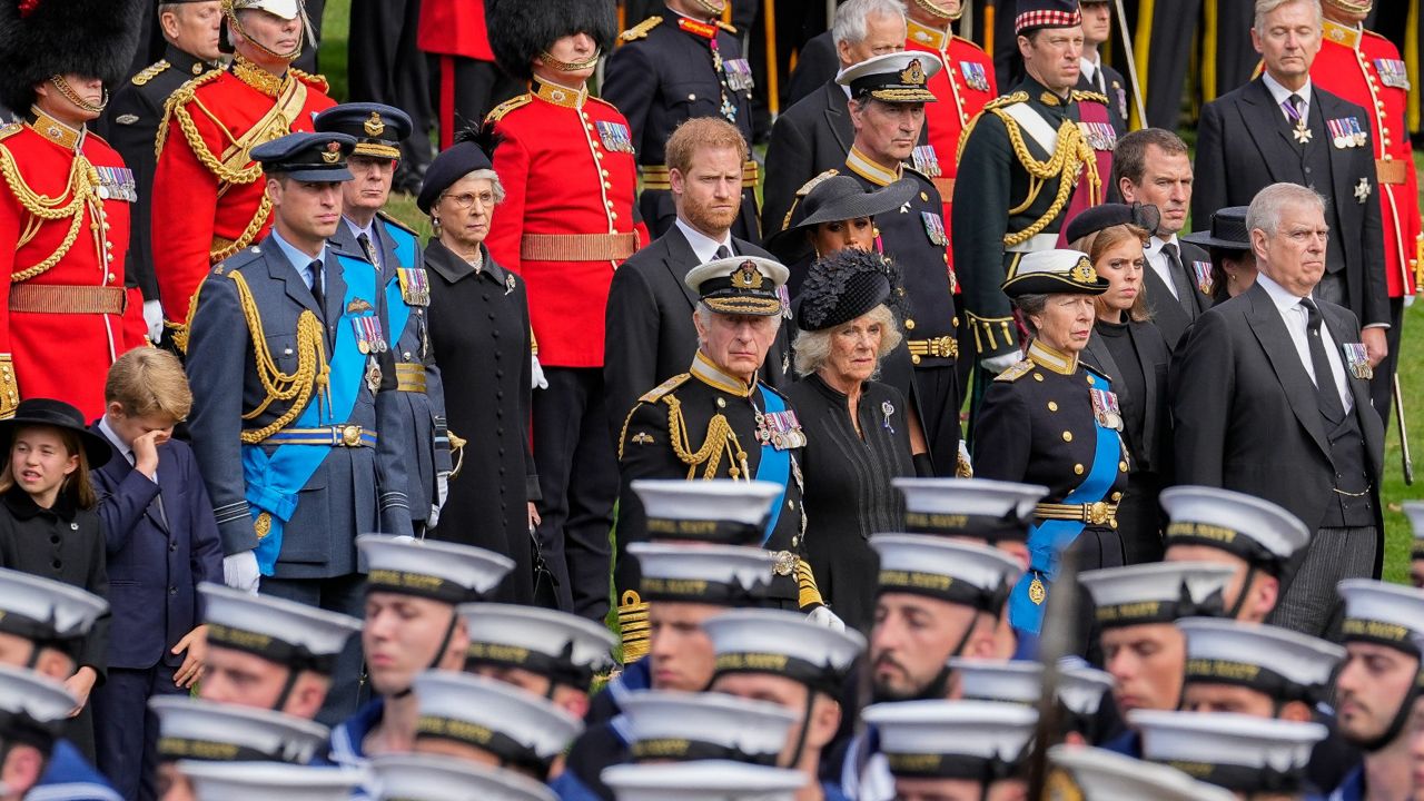 Members of the royal family watch as the coffin of Queen Elizabeth II is placed into the hearse following the state funeral service in Westminster Abbey. (AP Photo/Martin Meissner, Pool)