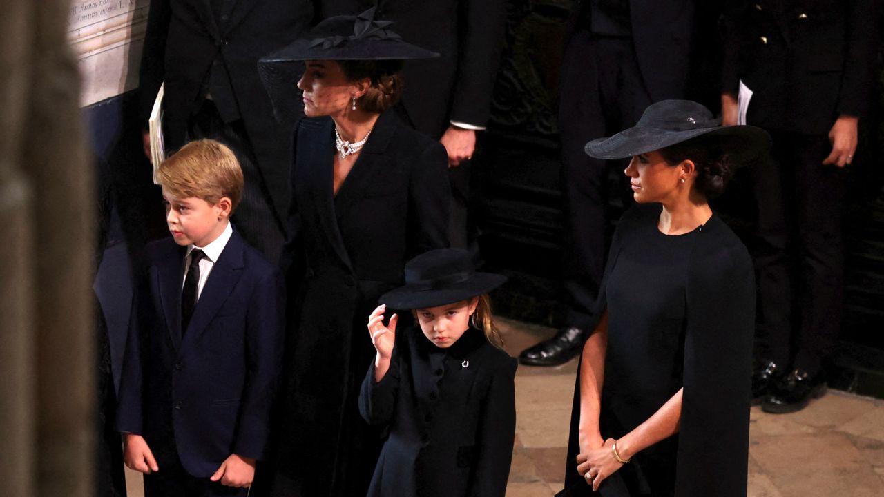 Kate, princess of Wales; Meghan, duchess of Sussex; Prince George and Princess Charlotte arrive at Westminster Abbey. (Phil Noble/Pool Photo via AP)