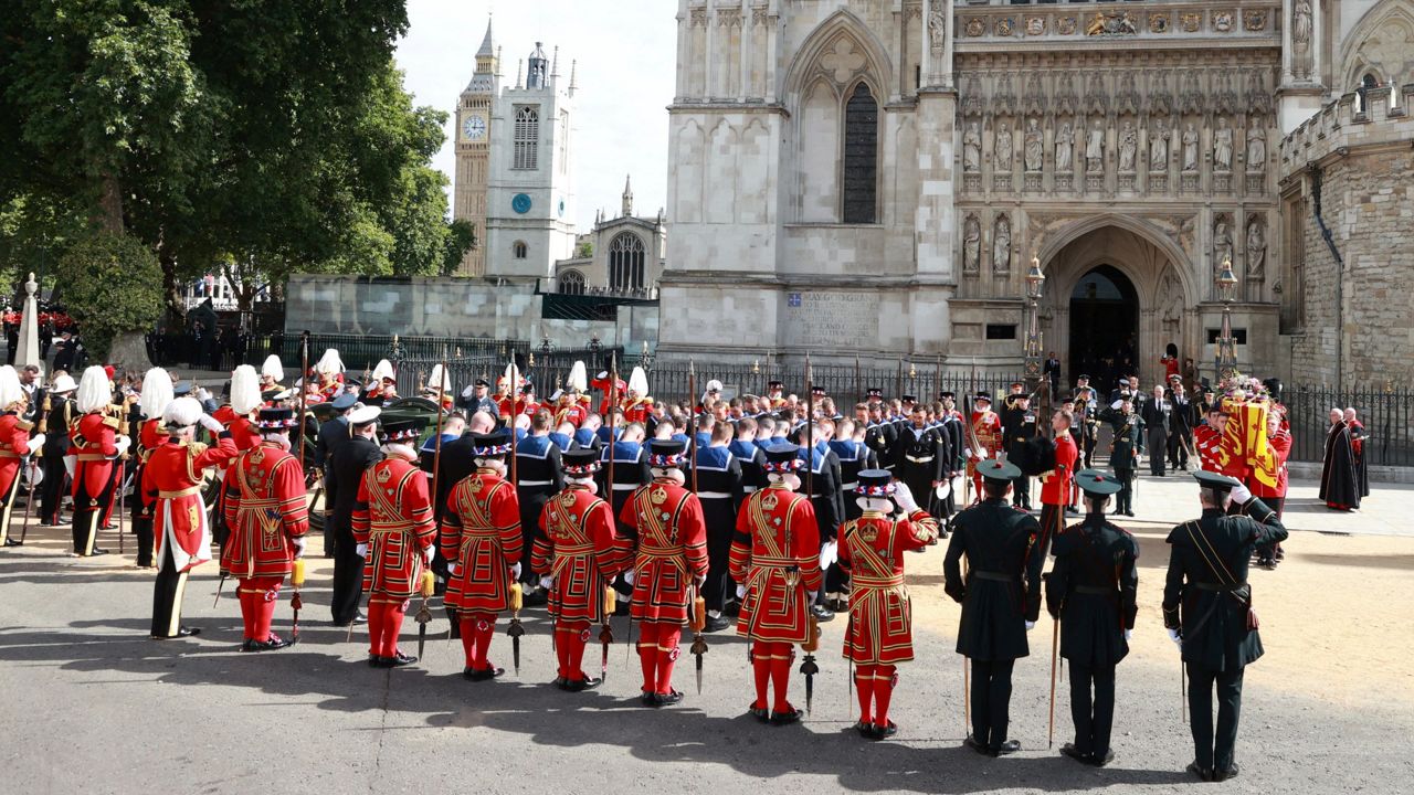 Queen Elizabeth's coffin is carried out of the Westminster Abbey. (Hannah Mckay/Pool Photo via AP)