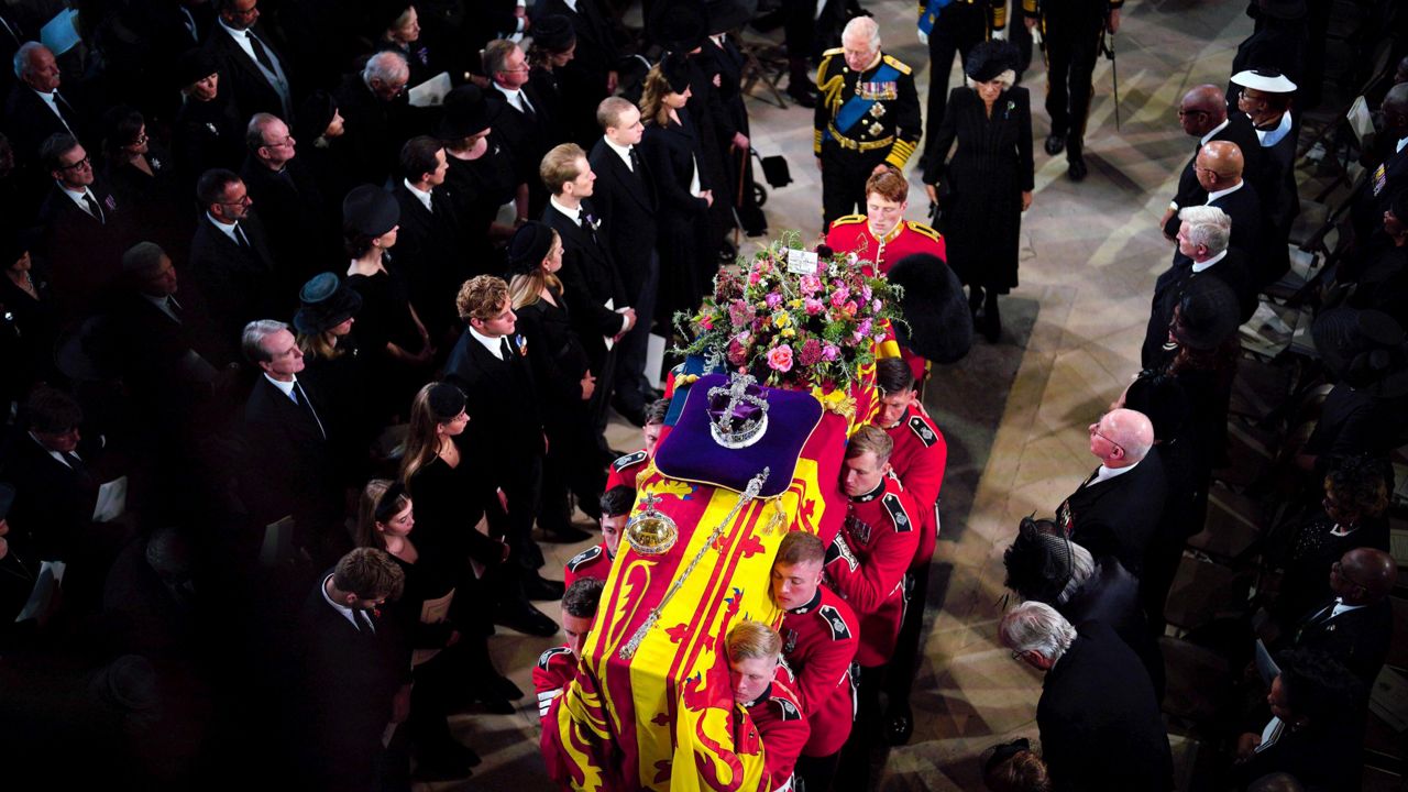 King Charles III and the queen consort follow the coffin during the committal service for Queen Elizabeth II at St George's Chapel at Windsor Castle. (Ben Birchall/Pool via AP)