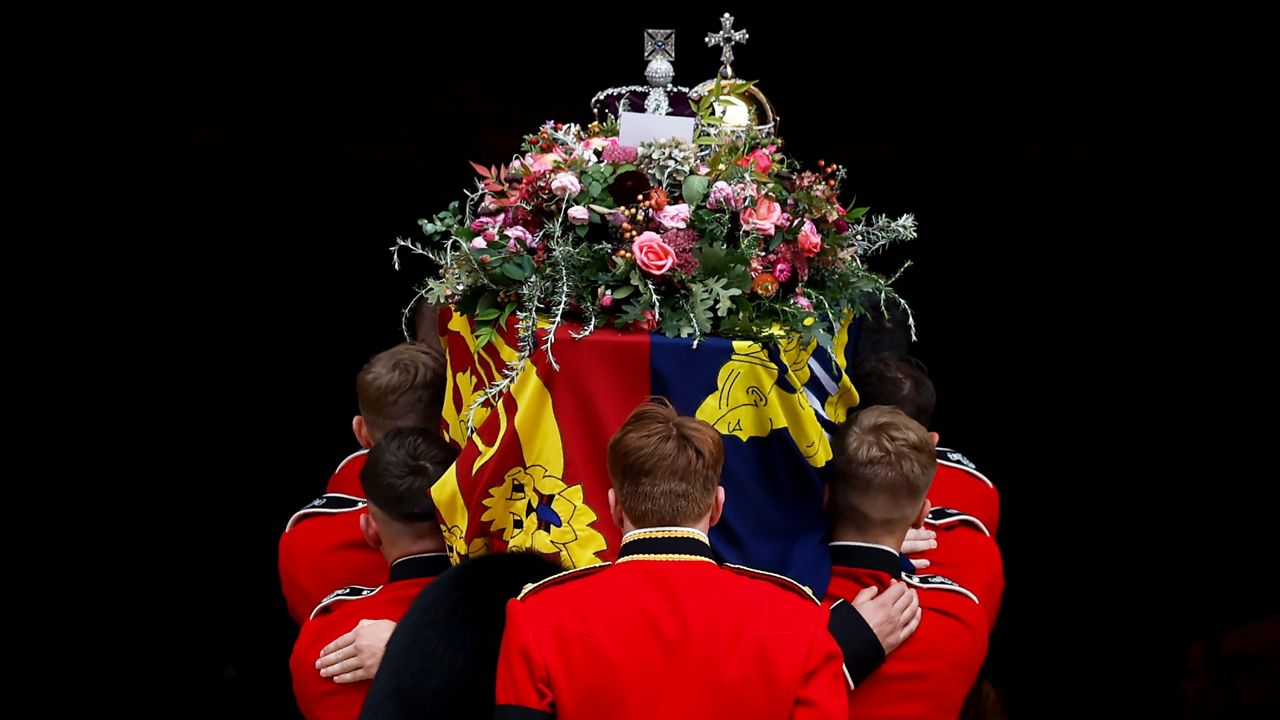 Pall bearers carry the coffin of Queen Elizabeth II with the Imperial State Crown resting on top into St. George's Chapel. (Jeff J Mitchell/Pool Photo via AP)