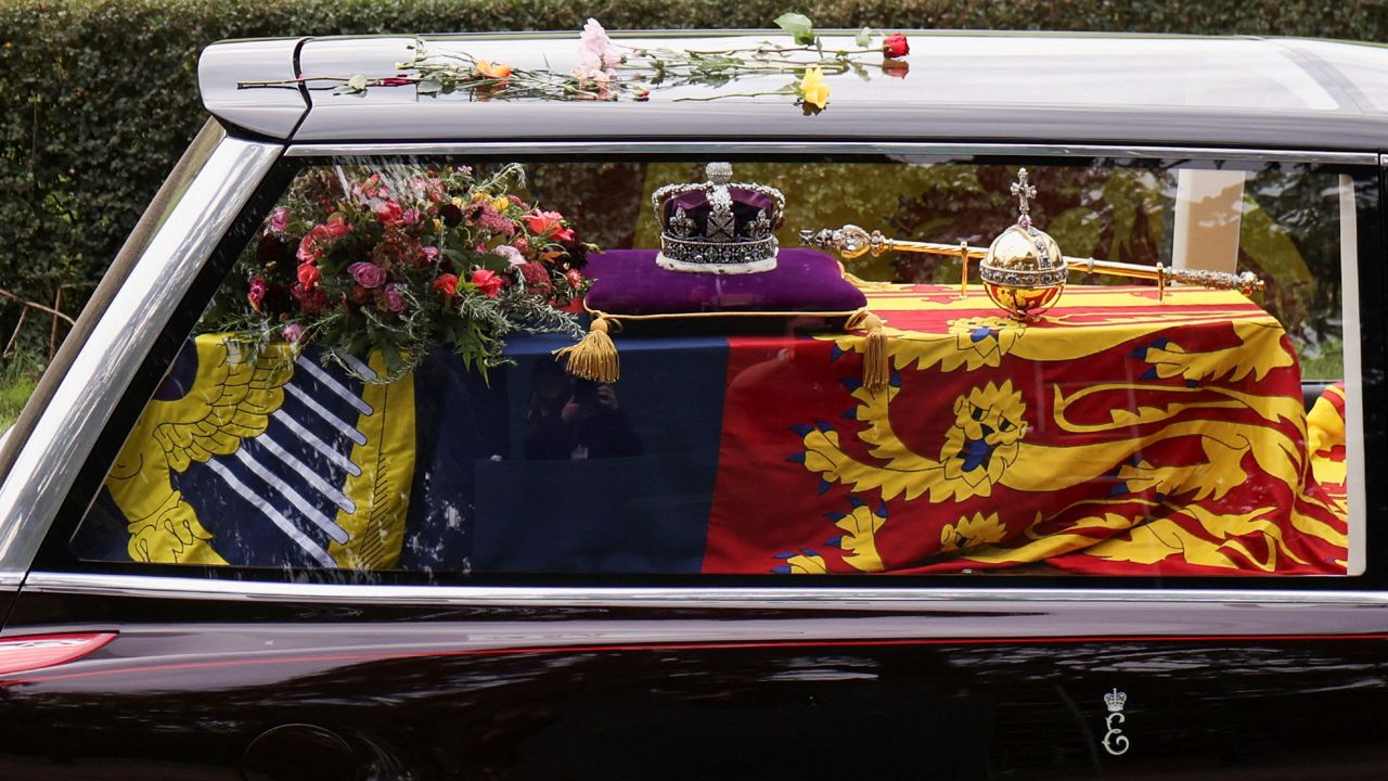 The hearse carrying the coffin of Queen Elizabeth II arrives on the Albert Road outside Windsor Castle. (Molly Darlington/Pool Photo via AP)