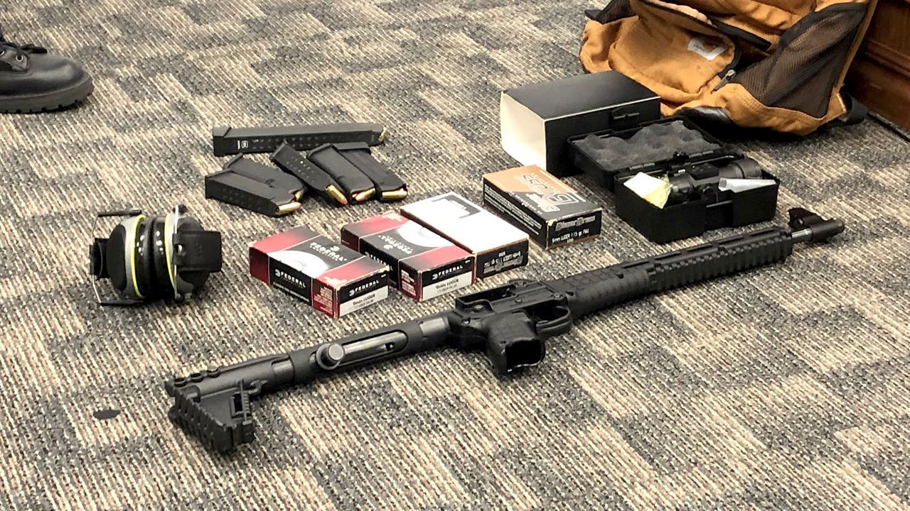 Police display a rifle and ammunition taken from a 19-year-old Embry-Riddle student who was arrested early Thursday after investigators say they were tipped off by concerned classmates that he was planning a mass shooting at the school. (Spectrum News 13/Brandon Jones)