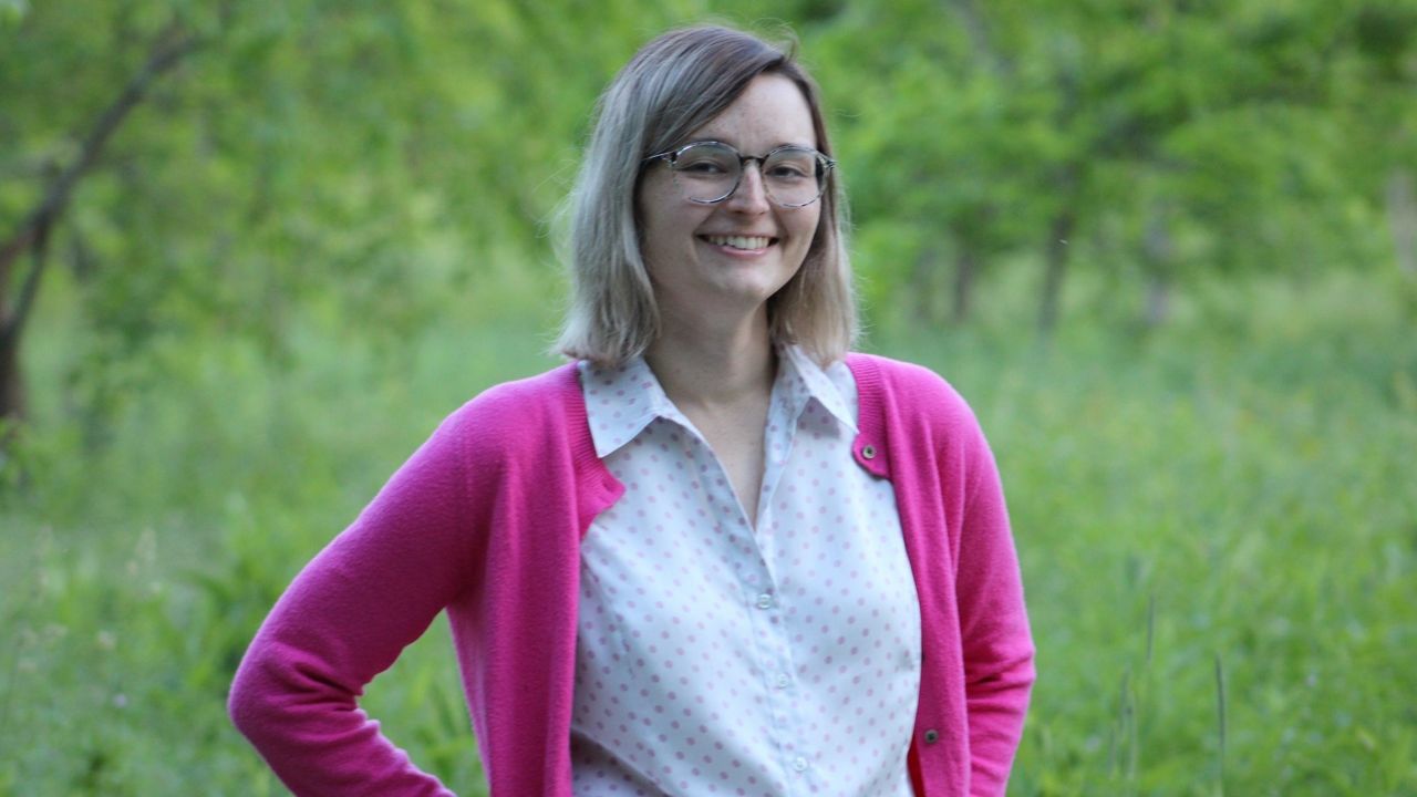 emma curtis in a pink cardigan