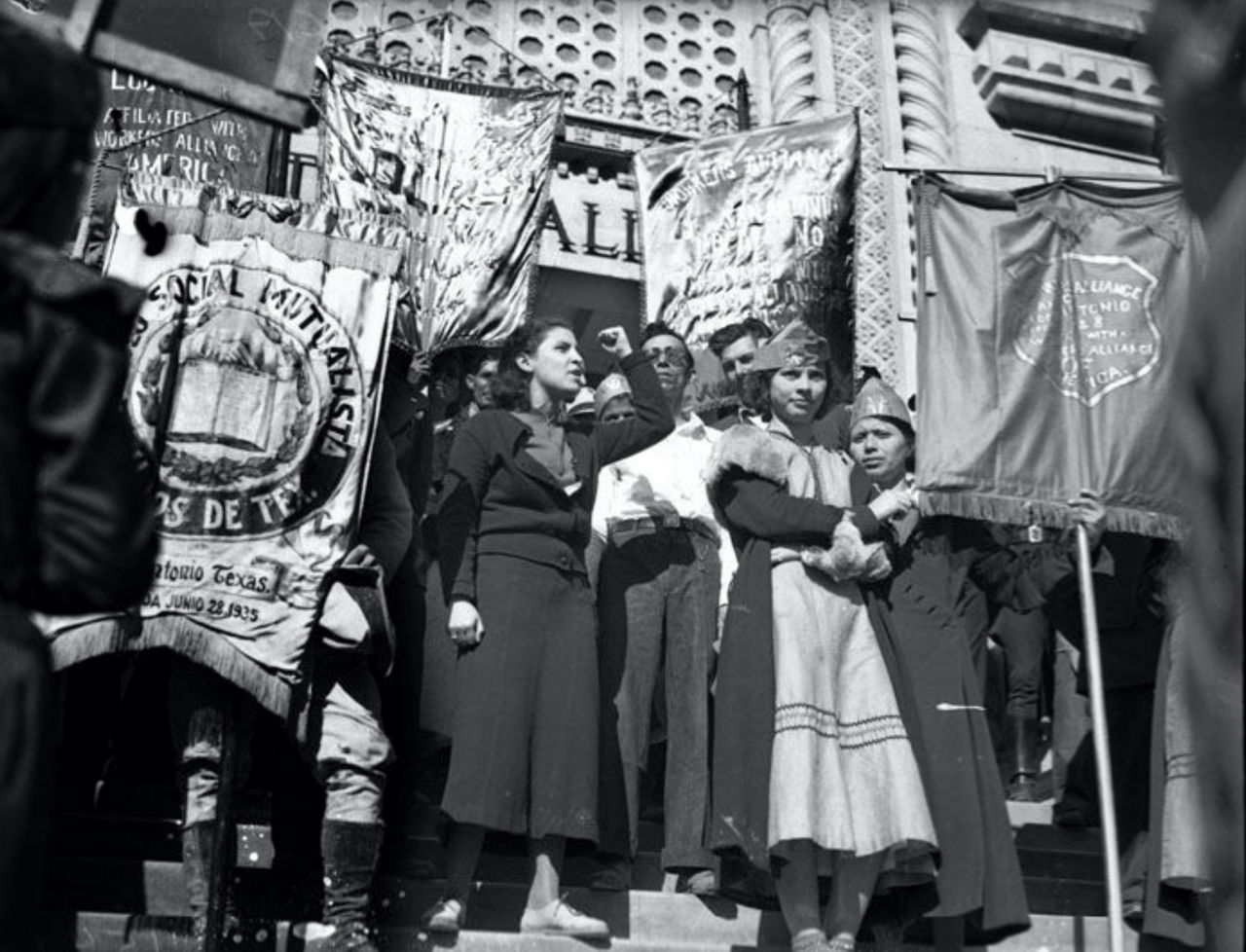 Emma Tenayuca standing outside of San Antonio's City Hall with a clenched fist in 1937. (San Antonio Light Photograph Collection, UTSA Special Collections)