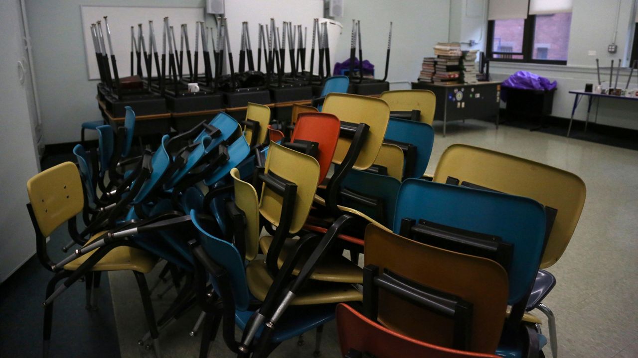 Empty classroom with stacked chairs (AP file photo)