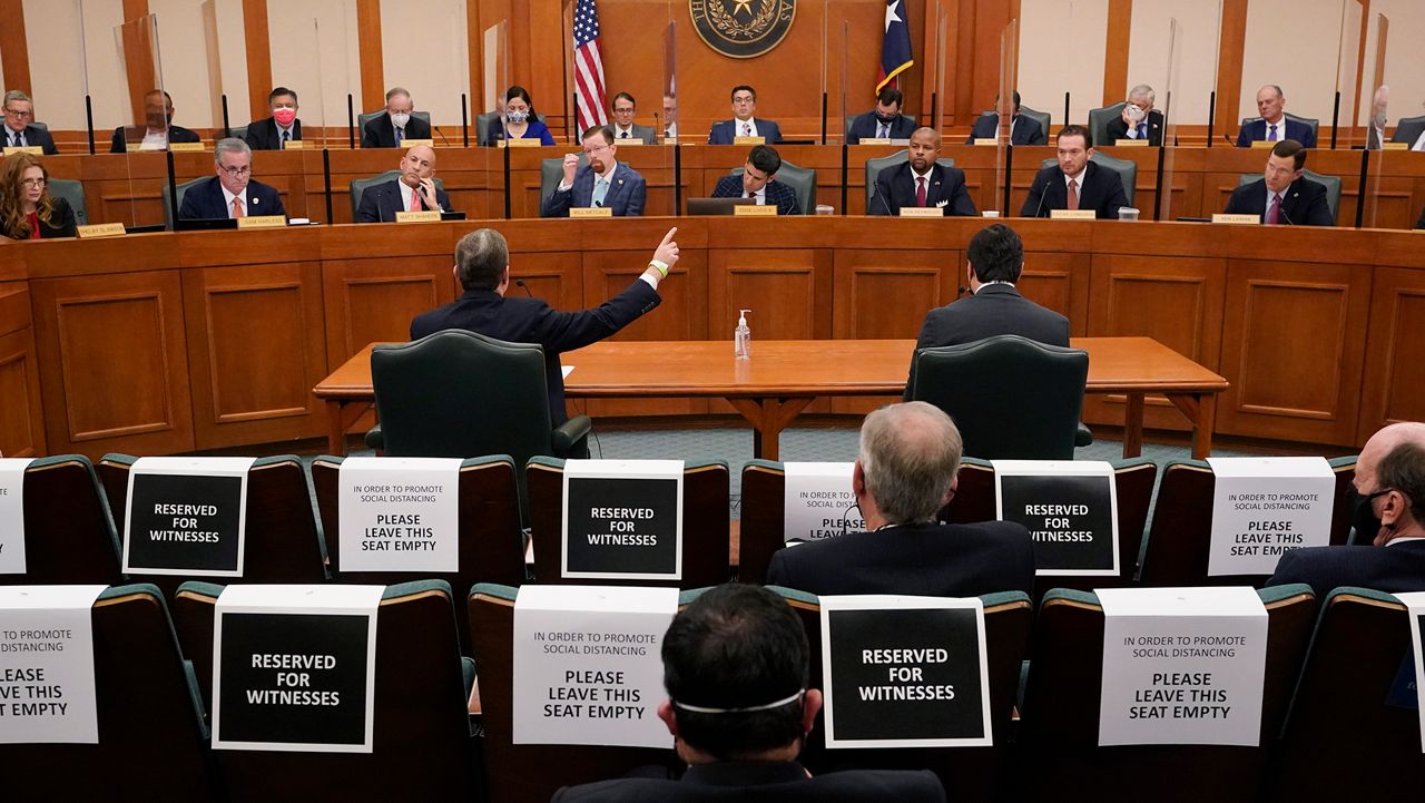 Curtis Morgan, the CEO of Vistra Corp., at table left, testifies as the Committees on State Affairs and Energy Resources holds a joint public hearing to consider the factors that led to statewide electrical blackouts, Thursday, Feb. 25, 2021, in Austin, Texas. The hearings were the first in Texas since a blackout that was one of the worst in U.S. history, leaving more than 4 million customers without power and heat in subfreezing temperatures. (AP Photo/Eric Gay)