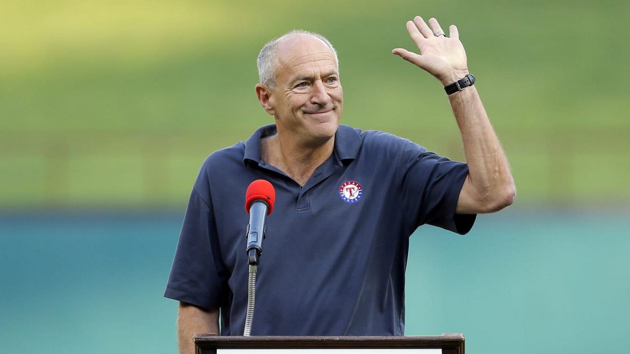Texas Rangers radio sports announcer Eric Nadel waves to cheering fans as he emcee's a pregame ceremony honoring Adrian Beltre before a baseball game against the New York Yankees on Friday, Sept. 8, 2017, in Arlington, Texas. Hall of Fame broadcaster Eric Nadel said Wednesday, March 22, 2023 that he will miss the start of his 29th season as the lead voice on Texas Rangers radio broadcasts while getting treatment for some mental health issues. (AP Photo/Tony Gutierrez, File)