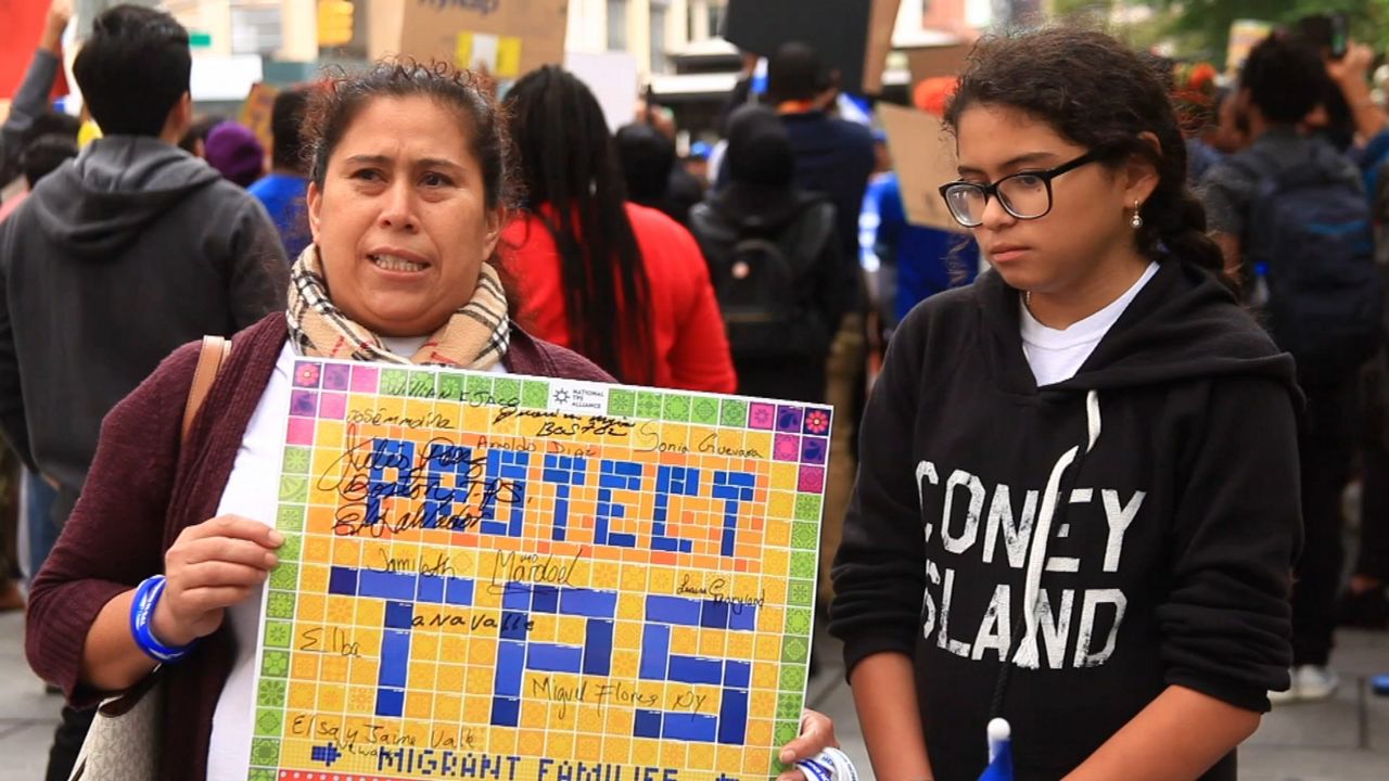 Individuals protest the Trump administration plan to end temporary protected status for several countries. (File photo)