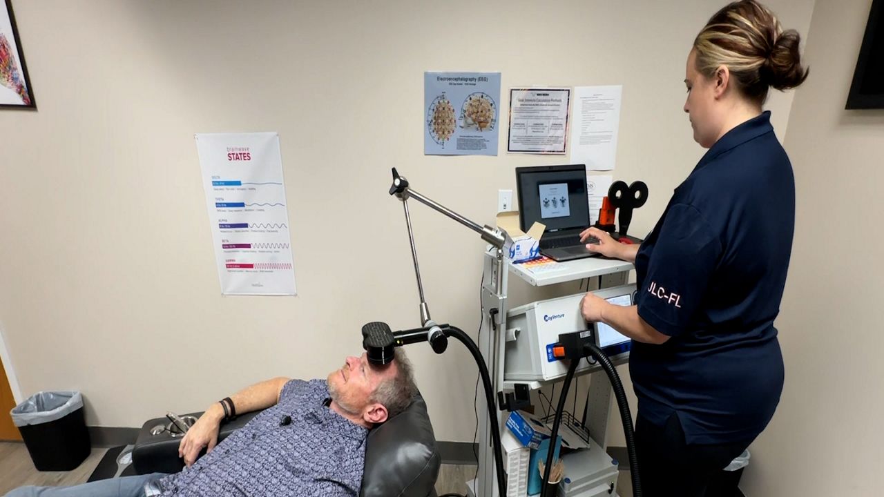 John Doolittle lays in a chair as he gets ready for his eTMS treatment. (Spectrum News)