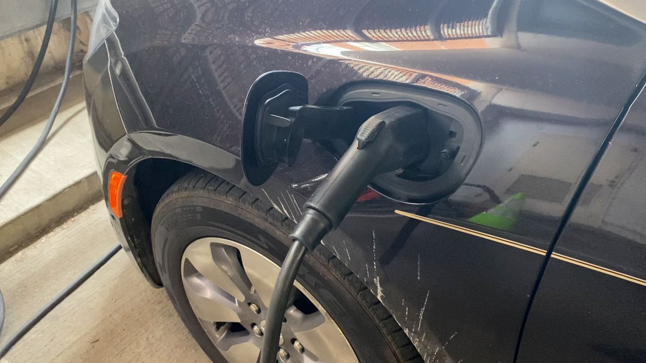 An electric vehicle plugged into a charging station in Covington, Ky. 
