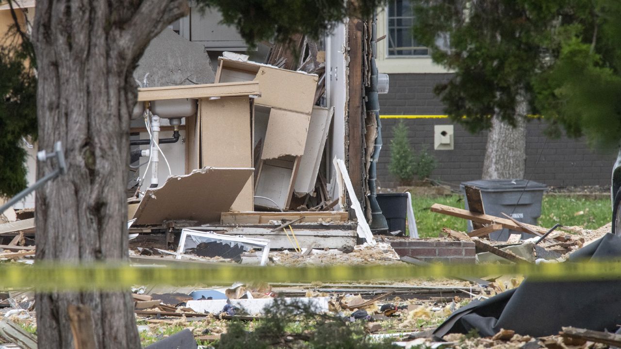 Emergency crews respond to a house explosion on North Weinbach Avenue in Evansville, Ind., Wednesday afternoon, Aug. 10, 2022. Several people were killed Wednesday when a house exploded in the southern Indiana city of Evansville, authorities said. (MaCabe Brown/Evansville Courier & Press via AP)