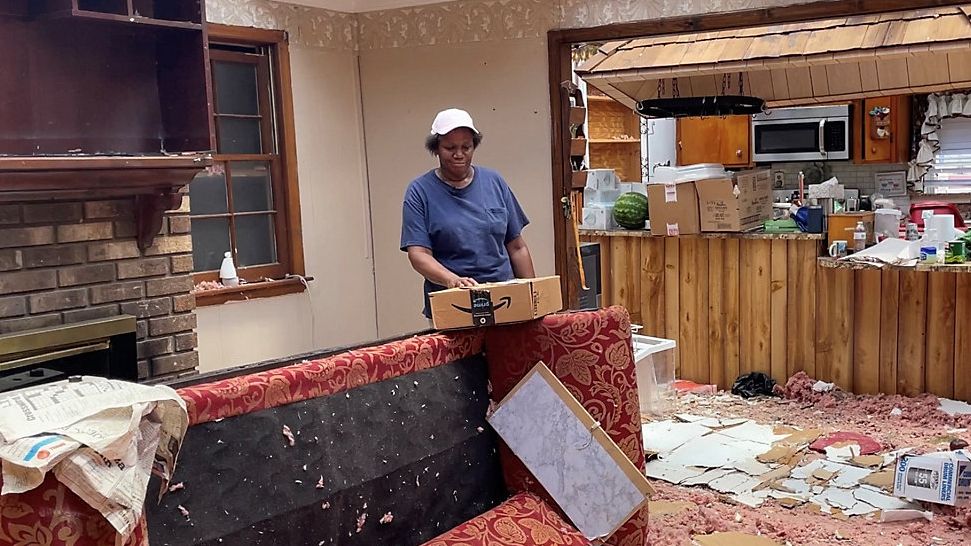 Evelyn Powell looks through her home after a powerful tornado struck Wednesday near Rocky Mount, N.C. (Spectrum News 1/Alex Wilkinson)
