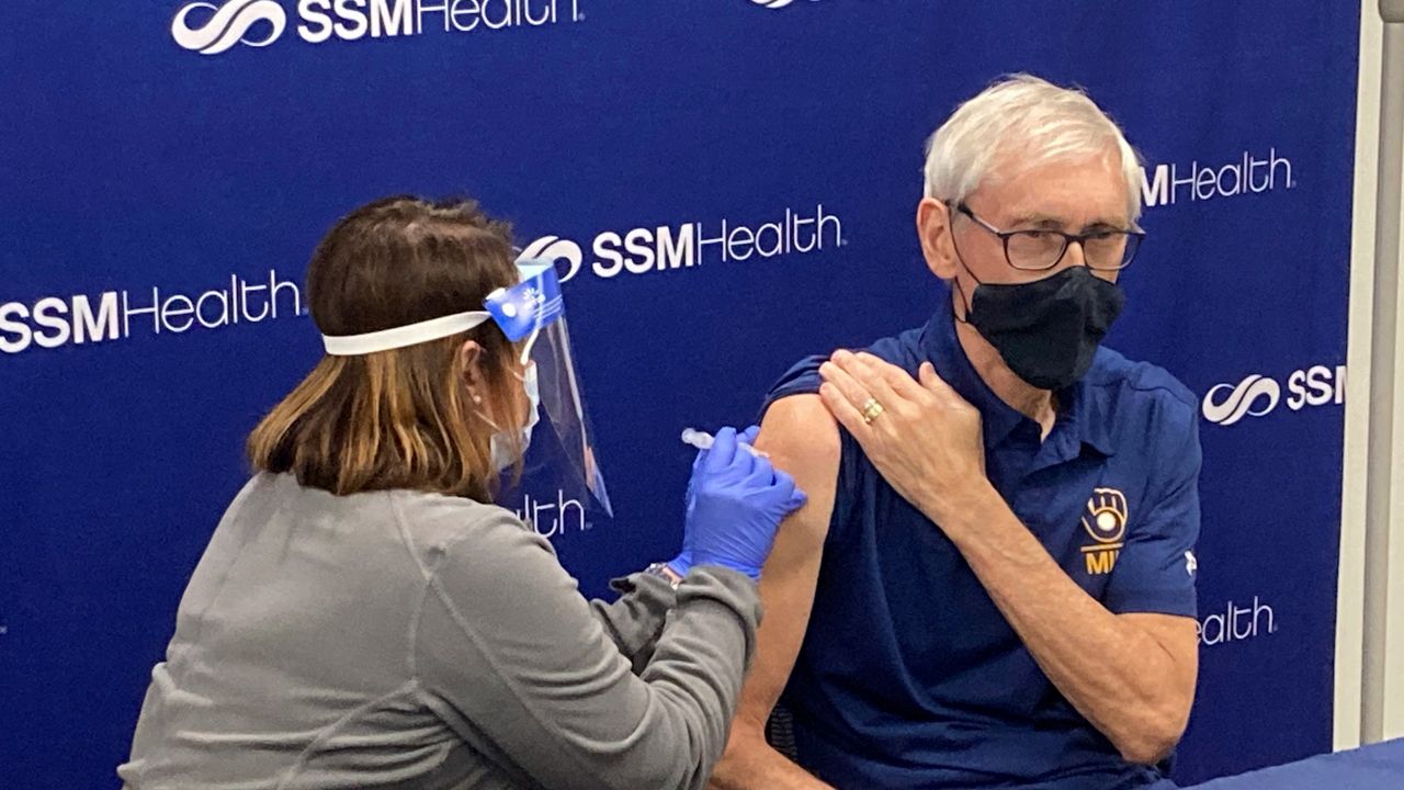 In this Feb. 12, 2021 file photo, Wisconsin Gov. Tony Evers receives his vaccination for the coronavirus from registered nurse Bobbie Rogers in Madison, Wis.