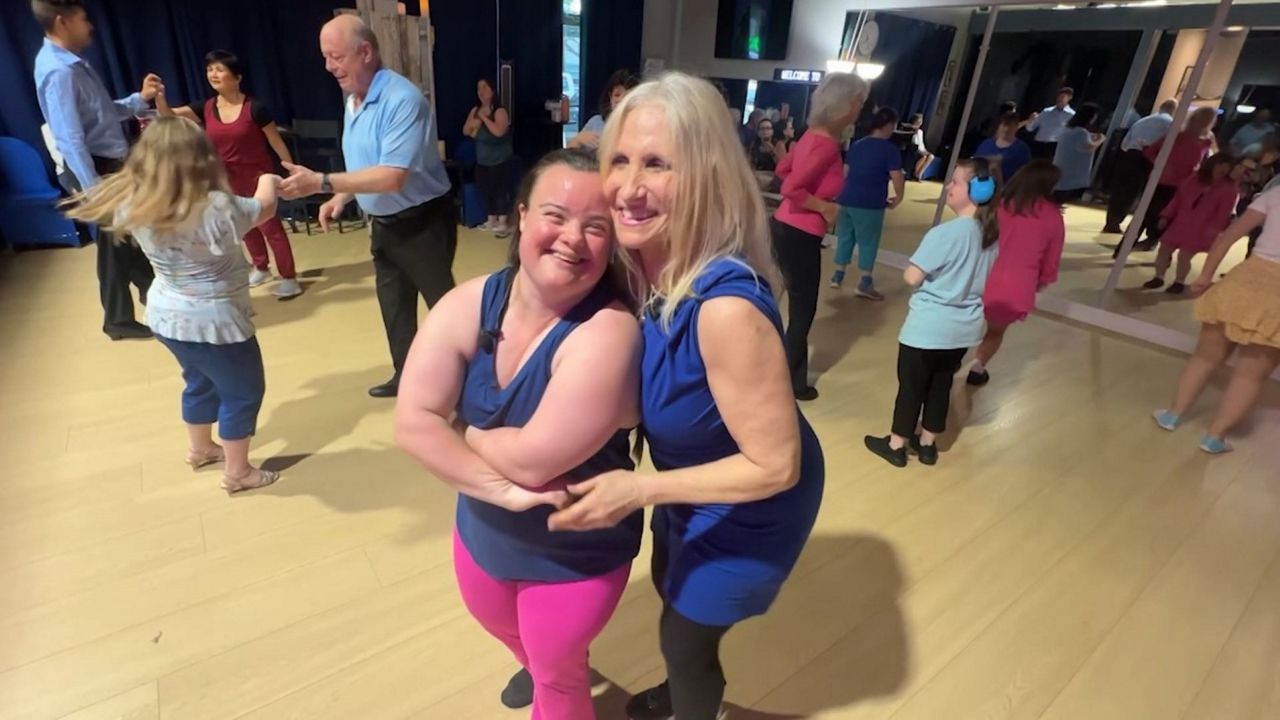 Corrine Rungo, who teaches a special needs dance class in Clearwater on Wednesdays, dances with one of her students. (Spectrum News/Rick Elmhorst)