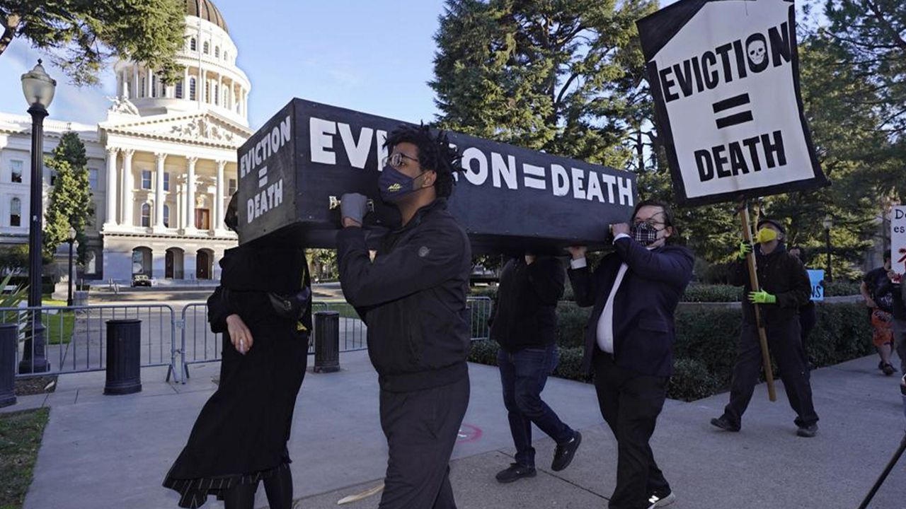 In this Jan. 25, 2021, file photo, demonstrators call for passage of rent forgiveness and stronger eviction protections legislation as they carry a mock casket past the Capitol in Sacramento, Calif. California's statewide eviction moratorium ends Friday, Oct. 1. (AP Photo/Rich Pedroncelli, File)