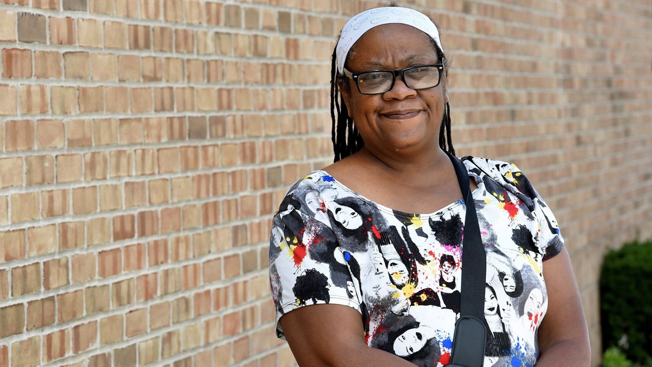 Regina Howard poses for a photo in Southfield, Mich.. Lakeshore Legal Aid helped her receive $24,550 in federal funds to pay for 15 months of rent. (AP/Jose Juarez)