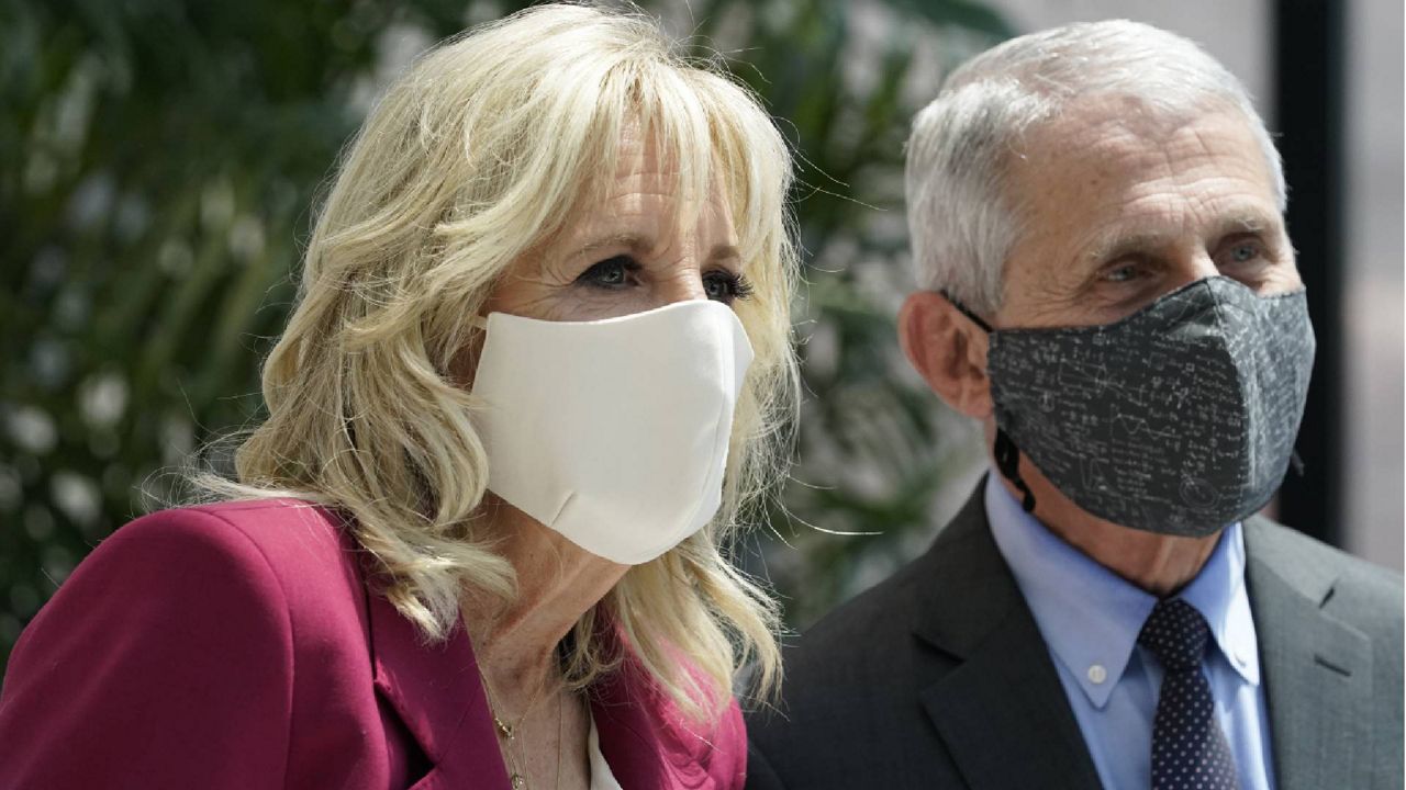 First lady Jill Biden, left, and Dr. Anthony Fauci, director of the National Institute of Allergy and Infectious Diseases, speak to members of the media, Thursday, May 20, 2021, as they tour a COVID-19 vaccination site at Children's Hospital in Washington. (AP Photo/Jacquelyn Martin)
