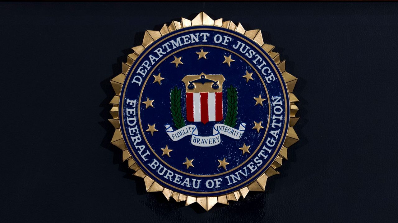 The FBI seal is displayed on a podium before a news conference at the agency's headquarters on June 14, 2018, in Washington. (AP Photo/Jose Luis Magana, File)