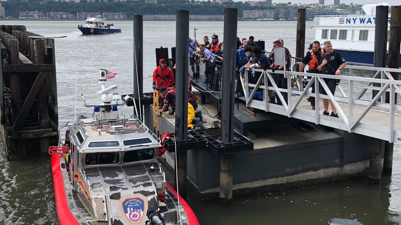 FDNY personnel and NY Waterways ferries responded to the scene after the boat capsized. (NY1/Dean Meminger)