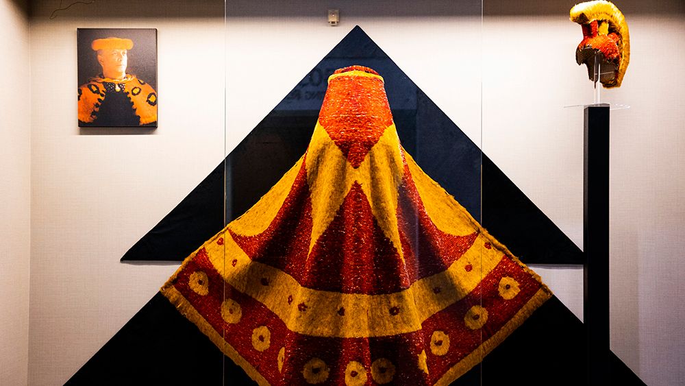 Hawaii Convention Center unveiled two exhibits, one showcasing the work of renowned featherwork master Rick San Nicolas, and the other, a permanent exhibit of The Healer Stones of Kapaemahu. Pictured: Replica of the cloak of King Pi‘ilani of the Kingdom of Maui, measuring nine feet at its widest point and 68 inches in length. The cloak is made with feathers from the Lady Amherst pheasant and the Chinese Golden pheasant. (Photo courtesy of Hawaii Convention Center)