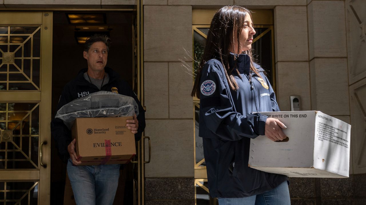 Federal agents carrying evidence boxes walk out of a Park Avenue high-rise on Thursday, Sep. 1, 2022, in New York. FBI agents and Homeland Security Investigations personnel searched properties linked to Viktor Vekselberg, a close ally of Russian President Vladimir Putin. U.S. federal agents on Thursday simultaneously searched properties in Manhattan, the posh beach community of Southampton, N.Y., and on an exclusive Miami island that have been linked to the billionaire Russian oligarch whose $120 million yacht was seized in April. (AP Photo/Yuki Iwamura)