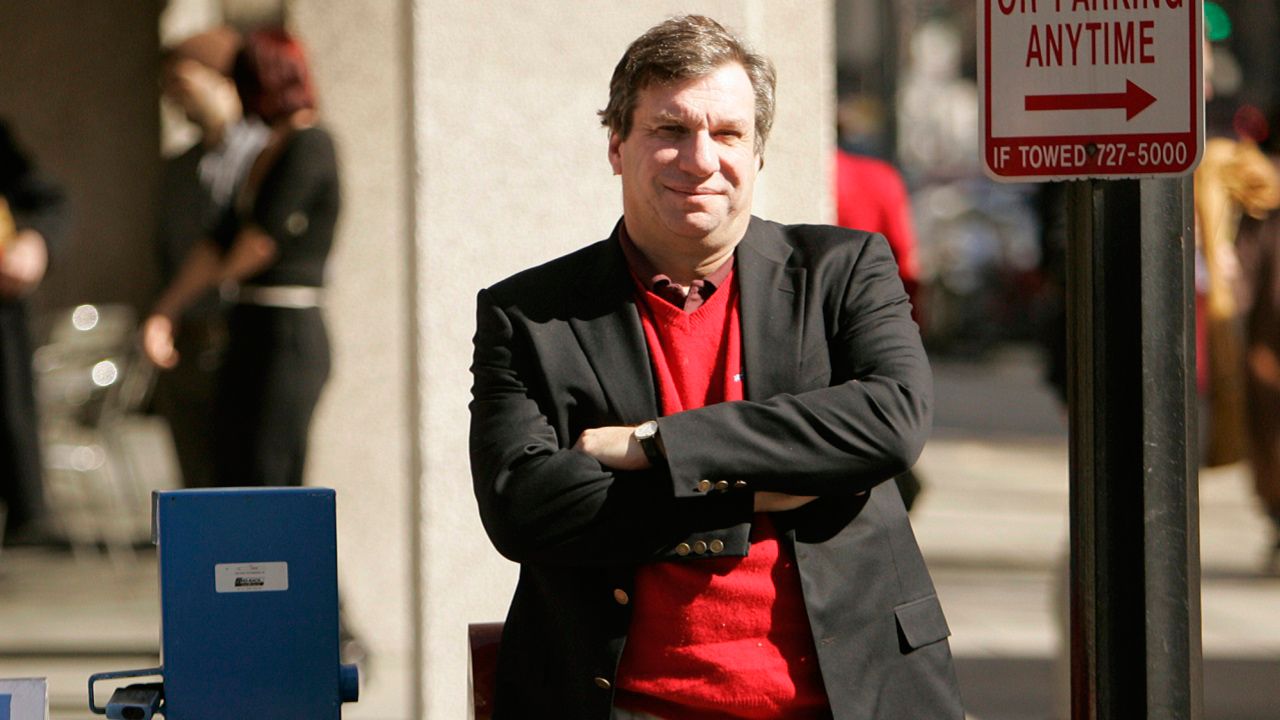 FILE - Sports writer and author John Feinstein poses in Washington, Feb. 28, 2006. (AP Photo Caleb Jones, file)