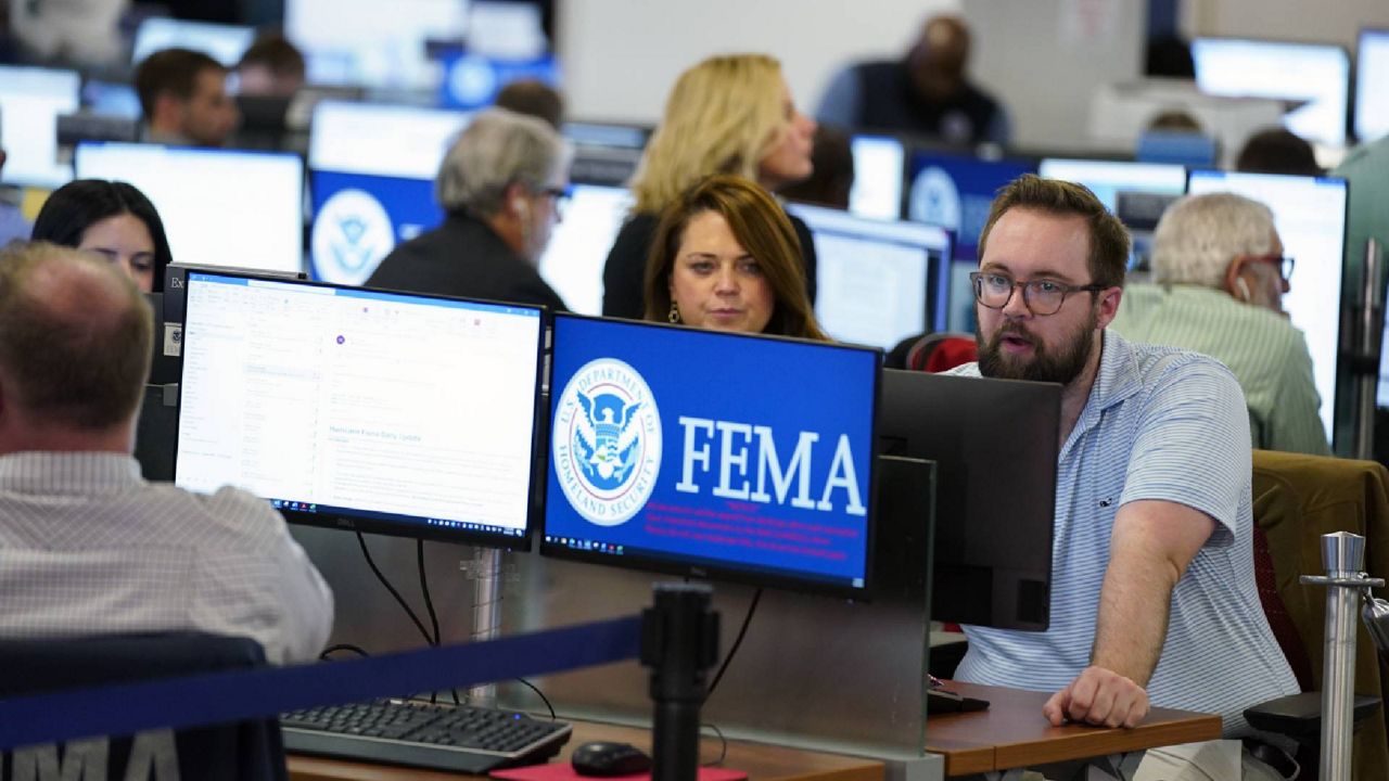 People work at FEMA headquarters, Thursday, Sept. 29, 2022, in Washington. (AP Photo/Evan Vucci)
