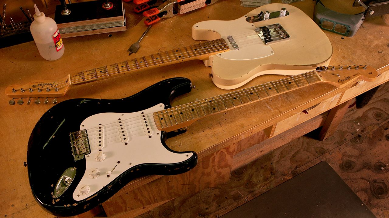 A Fender Custom Shop Stratocaster, front, and Telecaster sit on a workbench at Fender Musical Instrument Corp's factory in Corona, Calif. Thursday, Aug. 24, 2006. (AP Photo/Matt York)