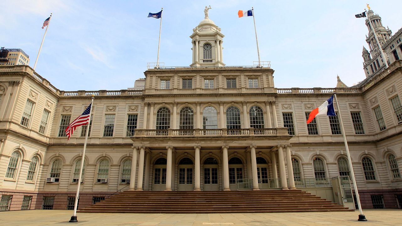 New York City's City Hall, shown from its south entrance, with a wide staircase and columns overlooking a courtyard. 